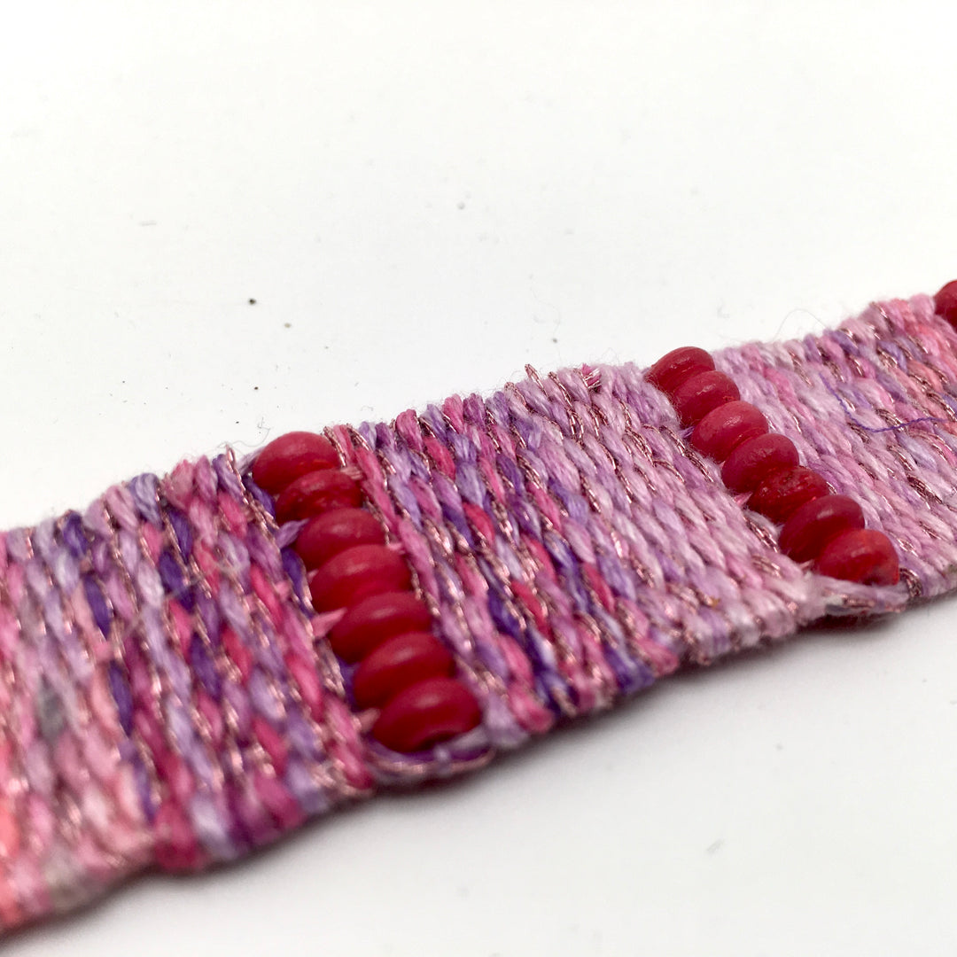Geweven armband in verschillende roze en lavendel tinten