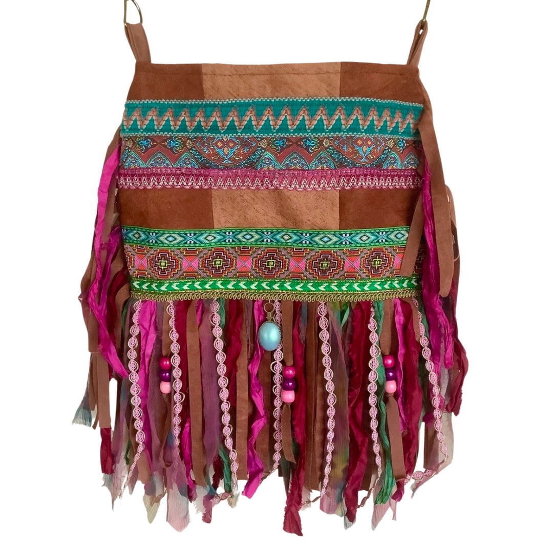 Colorful boho phone bag with pink and turquoise ethnic ribbons, layered fringe in pink and brown tones, and beaded accents