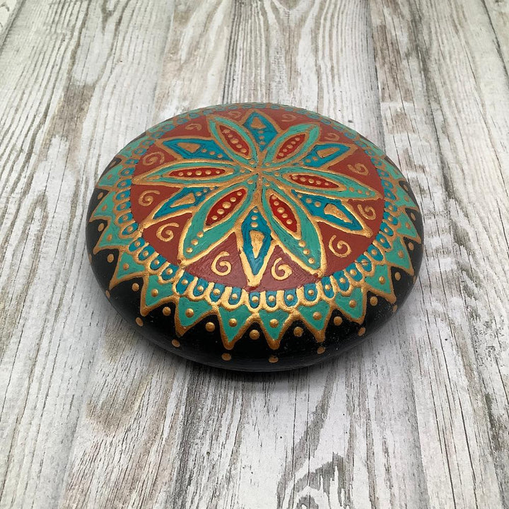 Hand-painted mandala stone in turquoise, red, and gold with a Southern-inspired design and glossy finish.