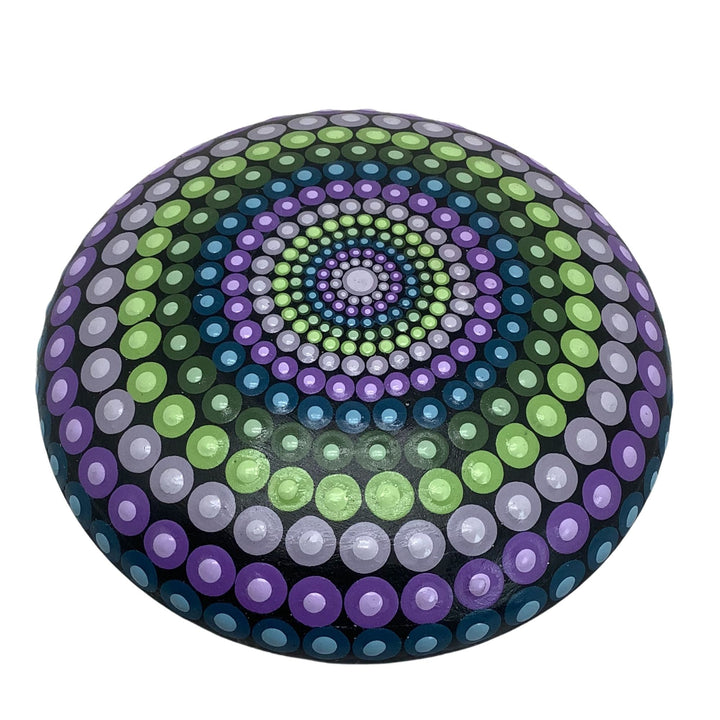Hand-painted mandala stone in purple, green, and blue hues with intricate dot art design.