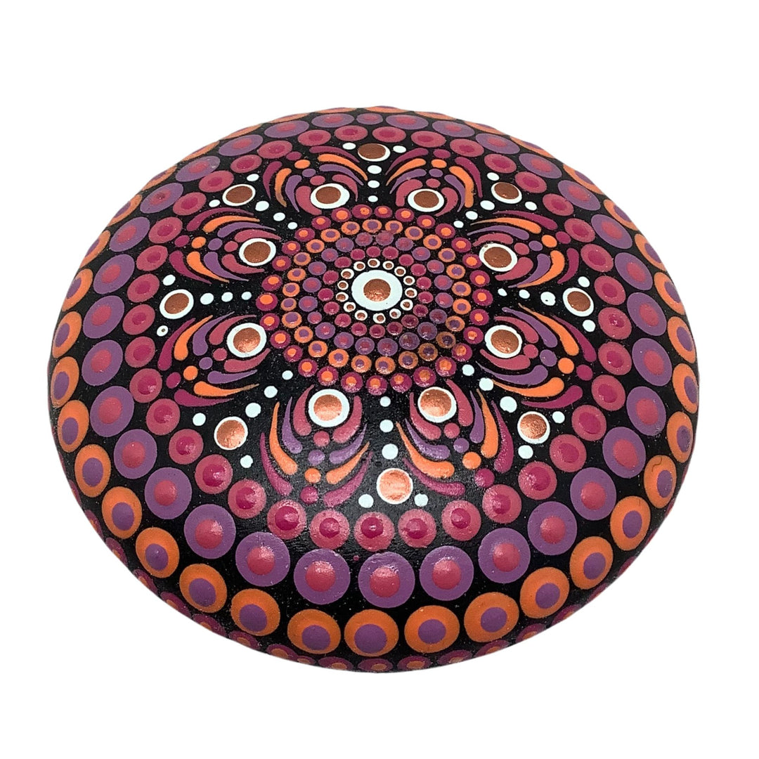 Hand painted mandala stone in pink, orange, and lavender with glossy finish, ideal for meditation, mindfulness, and boho home décor.