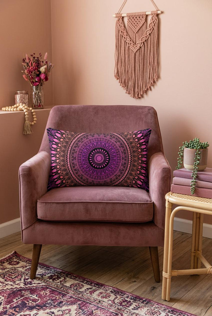 Boho lumbar pillow cover in pink, purple and black mandala design styled on a dusty rose armchair in a warm boho interior