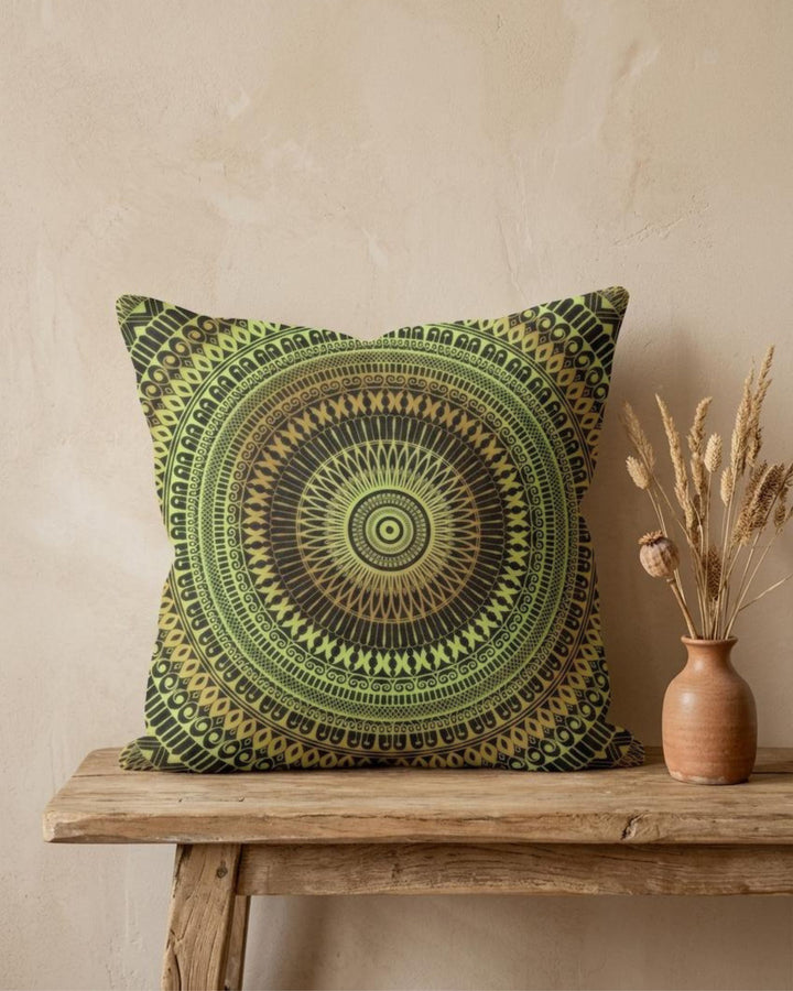 Boho pillow cover with green and yellow mandala design on a rustic wooden table, styled with a ceramic vase and dried grasses, warm natural light and textured neutral wall, premium linen-look fabric