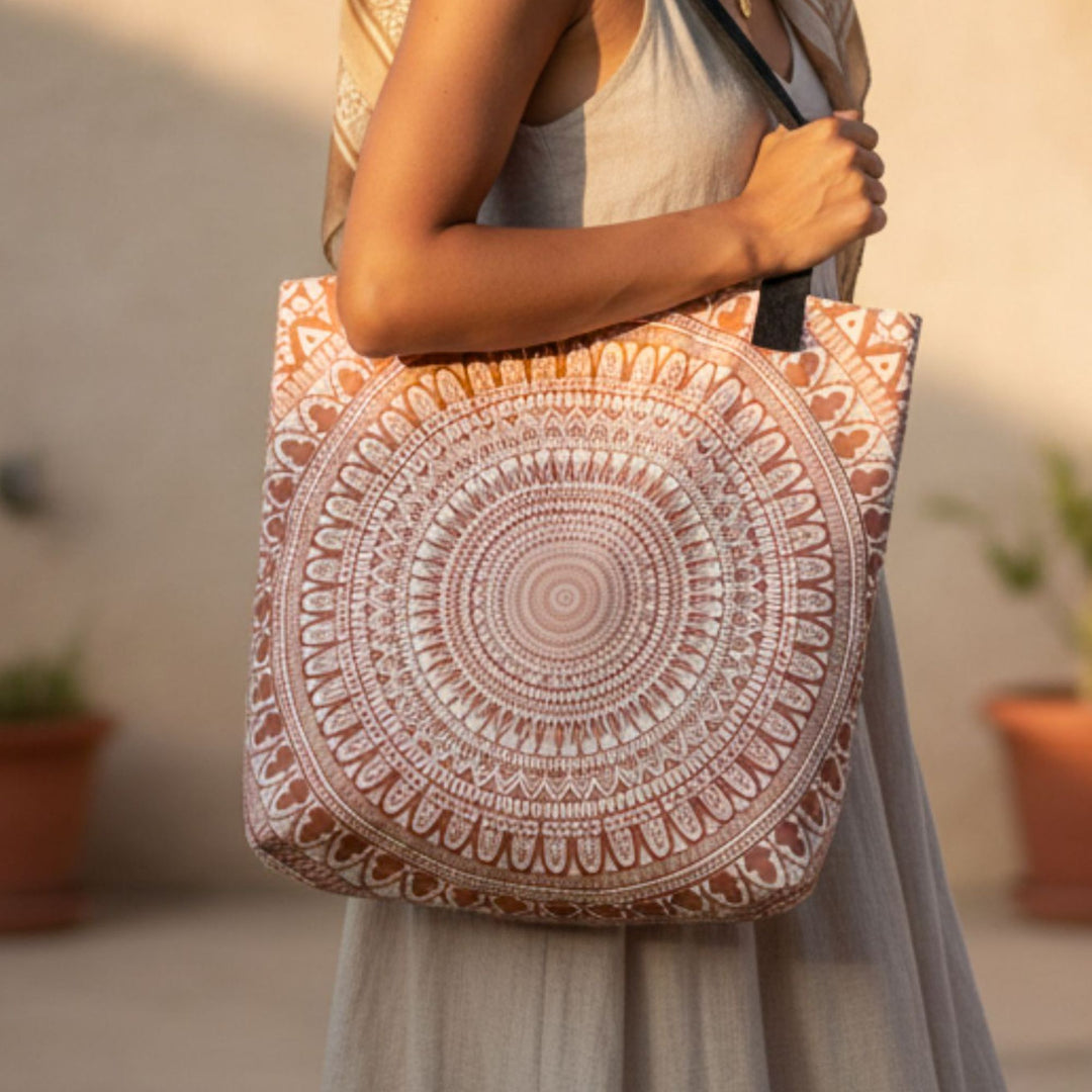 Person holding a patterned tote bag with a blurred background