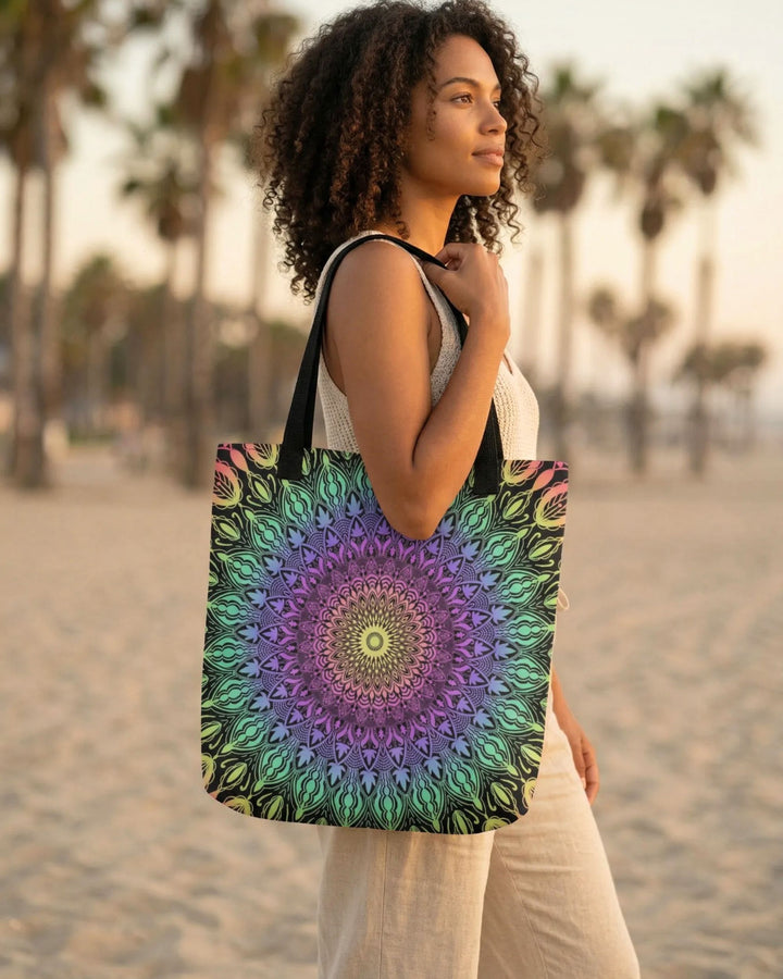 Bohemian tote bag with colorful mandala pattern worn by a woman with dark curly hair and sun-kissed skin, standing on a warm beach during golden hour, soft natural light, neutral outfit, relaxed lifestyle setting