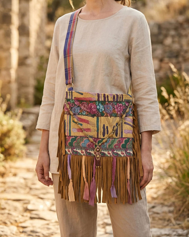 detail of a boho bag with fringe, beads and colorful patchwork fabrics, handmade and unique