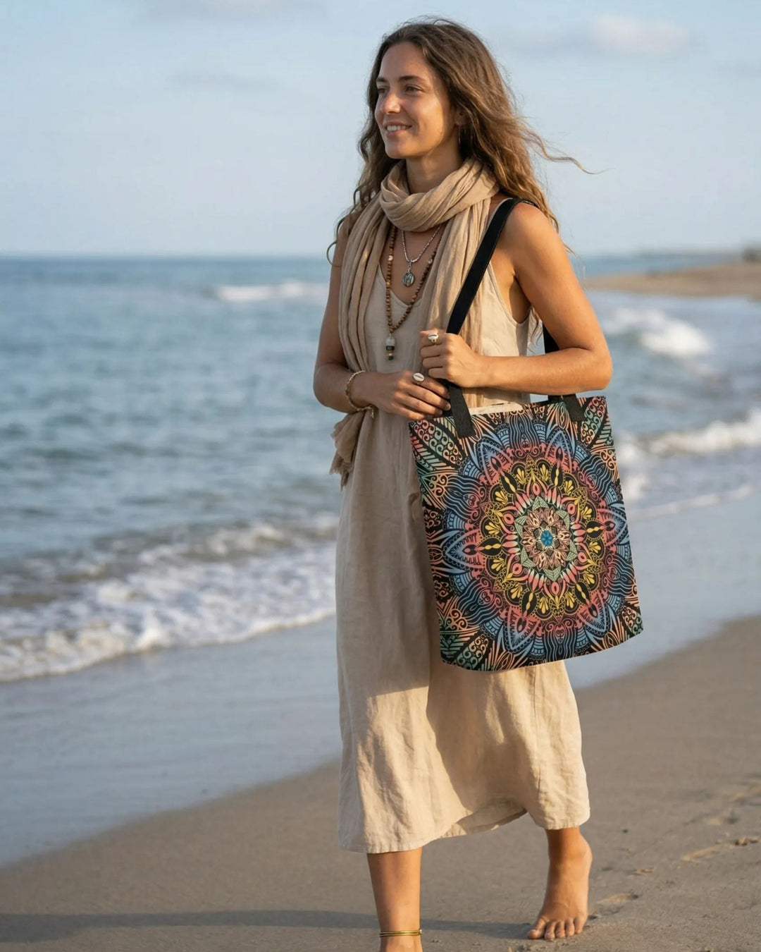 Boho mandala tote bag carried by a woman walking barefoot along a sandy beach