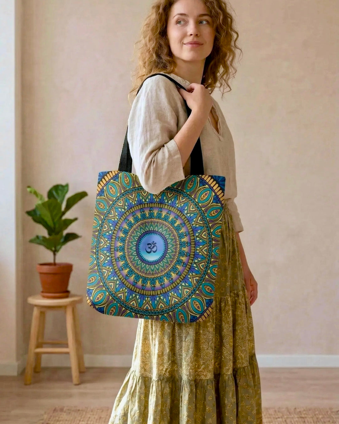 bohemian tote bag with mandala design and om symbol worn by woman in soft natural outfit