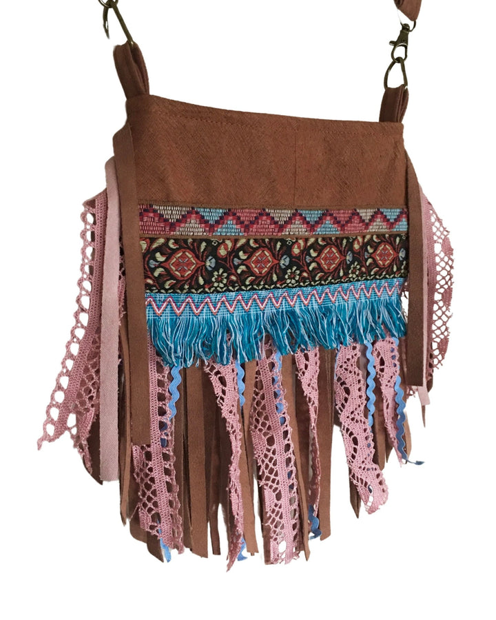 Brown handbag with colorful fringe and patterned strap on a white background