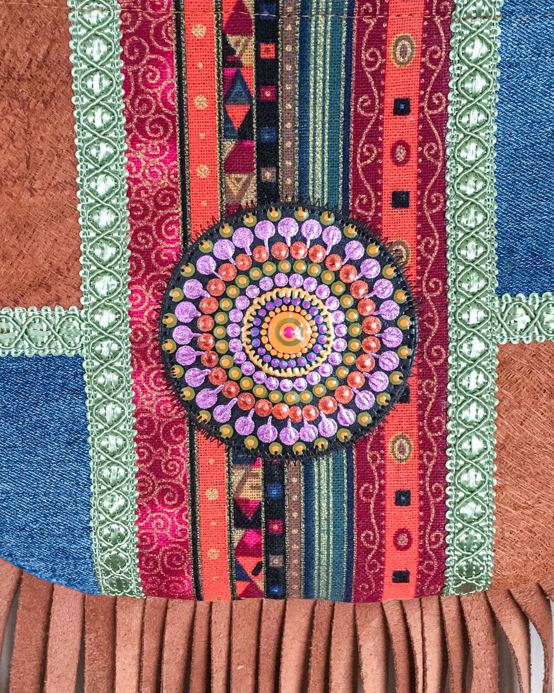 Colorful woven textile with a circular mandala pattern and fringe details