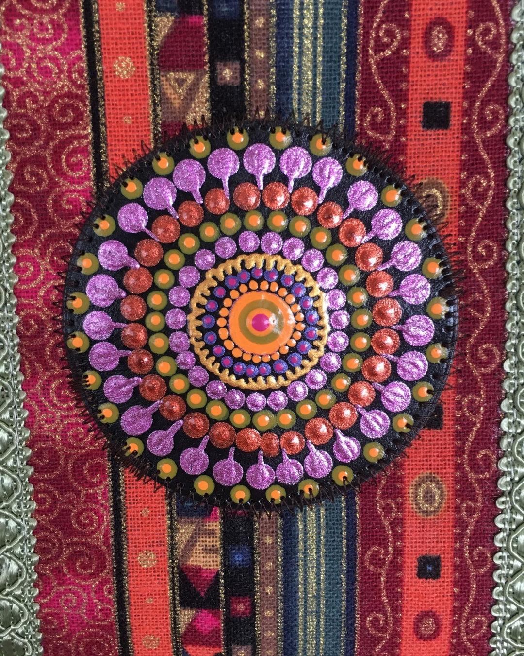 Colorful mandala pattern on a textured fabric background