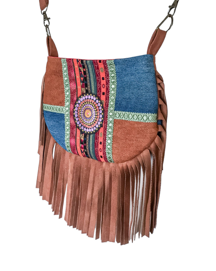 Multicolored handbag with fringe and a central decorative element on a white background
