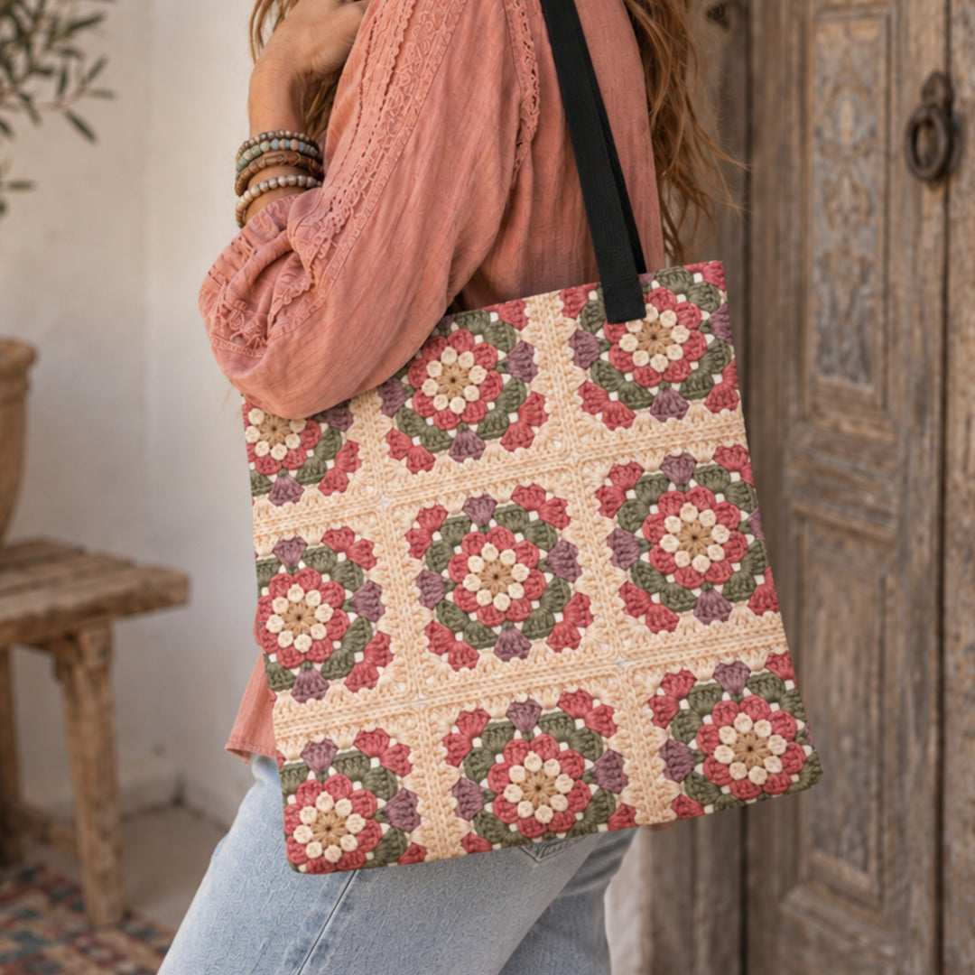 Boho woman carrying a floral granny square printed tote bag with black handles