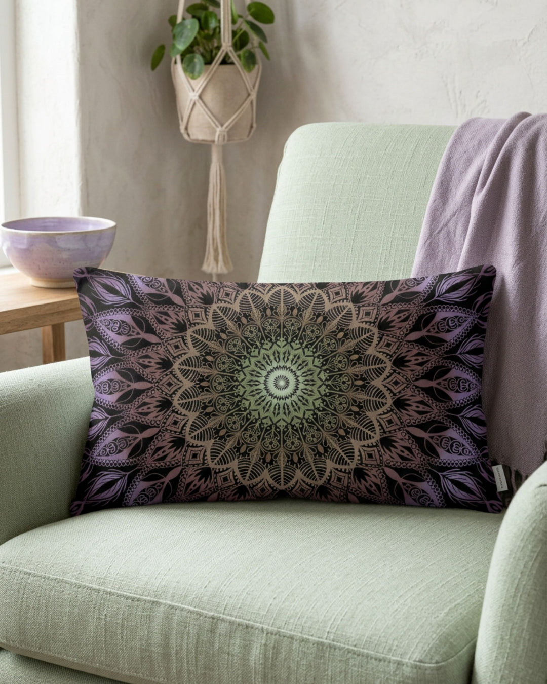Boho lumbar pillow cover with lavender and soft green mandala design styled on a pale green armchair in a calm boho interior