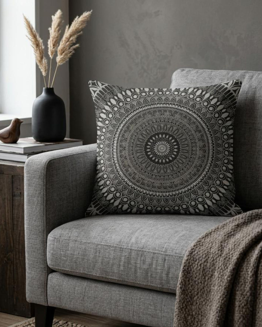 Boho square pillow cover in black, white and grey mandala design styled on a warm grey sofa in a sophisticated modern boho interior