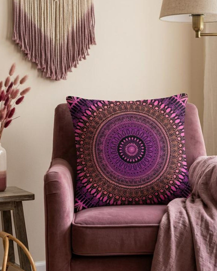 Purple mandala pillow on a pink armchair with decorative elements in the background