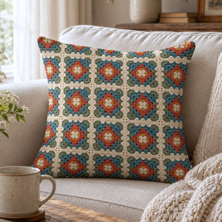 Granny square pillow cover with printed crochet look styled in a cozy cottage interior