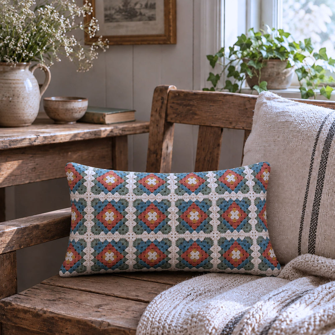 Granny square pillow cover with printed crochet look styled in a rustic cottage room