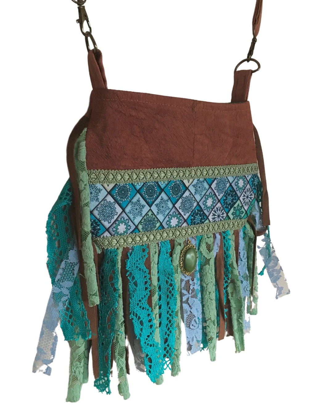 Brown bag with green and blue lace details on a white background
