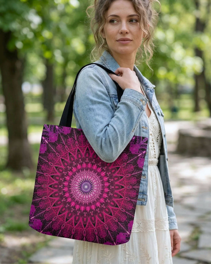 woman wearing boho tote bag with pink mandala print, styled with light dress and denim jacket in natural park setting