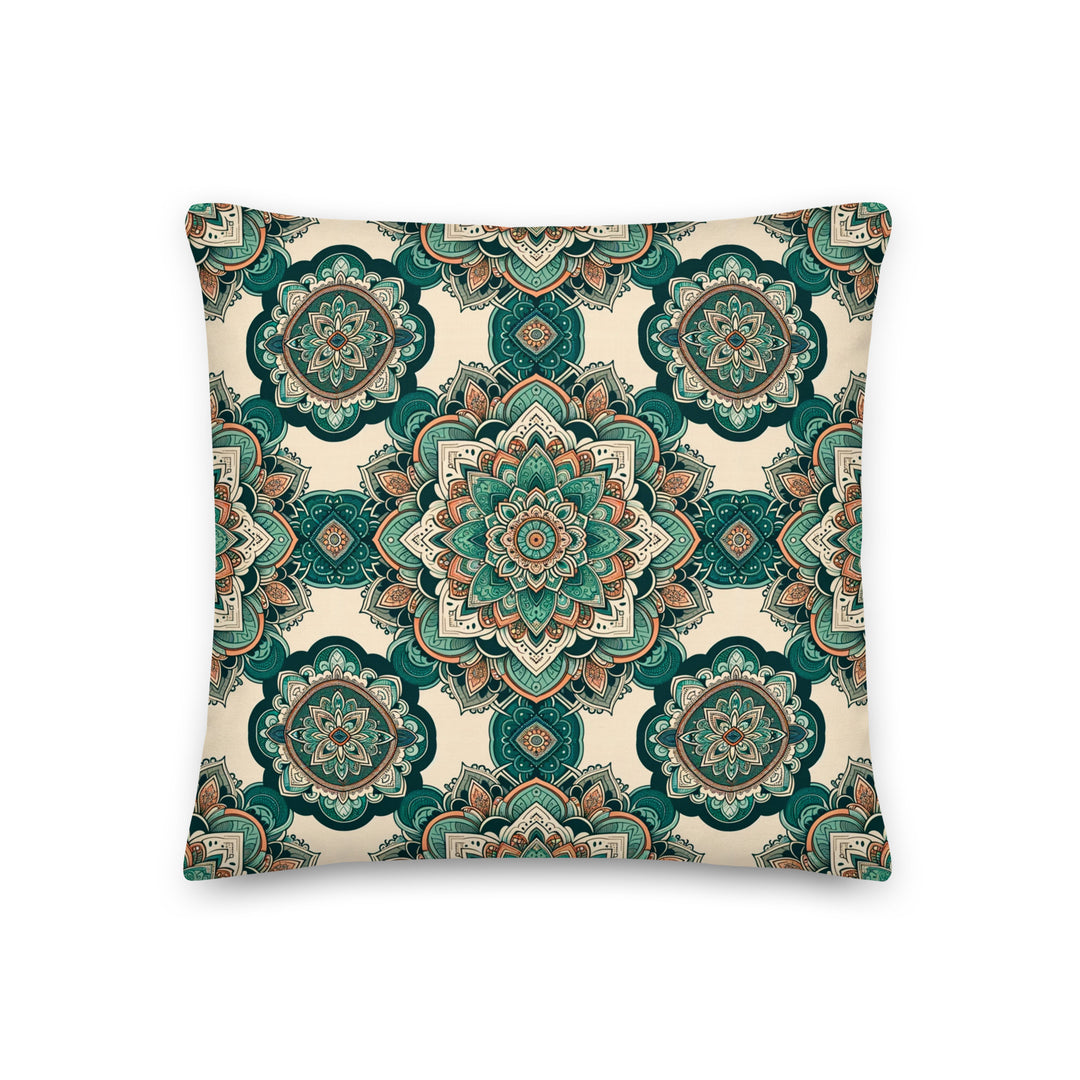 A decorative pillow with intricate mandala designs in shades of green, teal, and earthy tones, set against a light background.