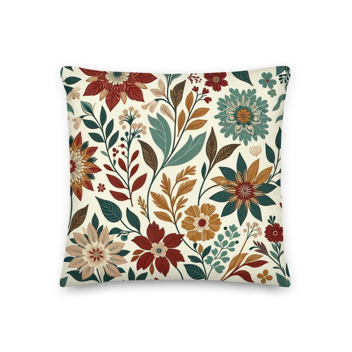 A decorative pillow with a beautiful floral pattern featuring various flowers and leaves in warm, autumnal colors