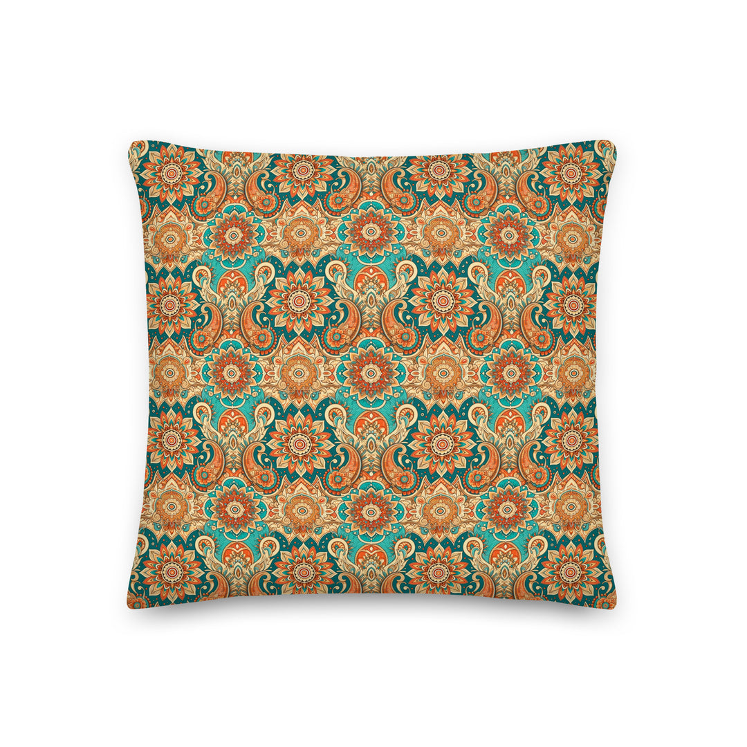 A decorative pillow with an intricate paisley and mandala pattern in vibrant hues of turquoise, orange, and gold, set against a light background.