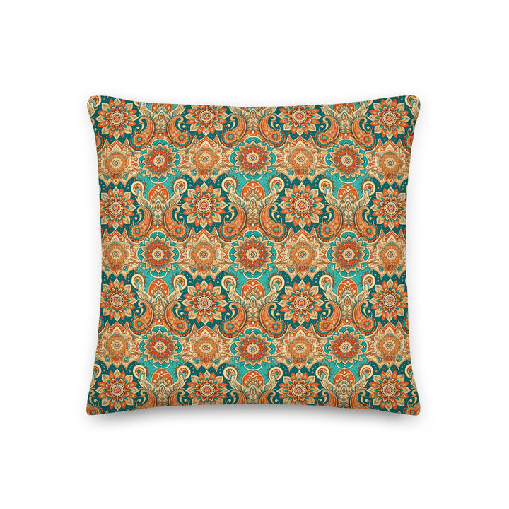 A decorative pillow with an intricate paisley and mandala pattern in vibrant hues of turquoise, orange, and gold, set against a light background.