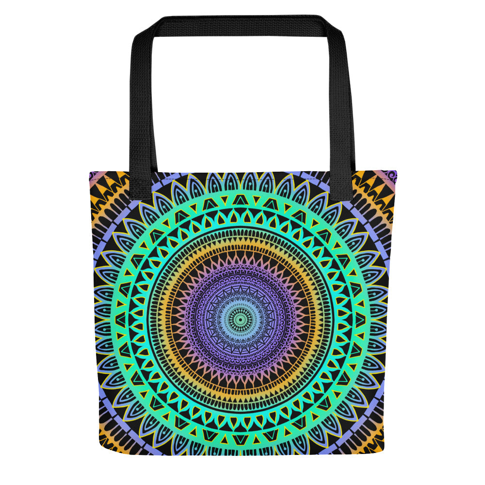 A tote bag with a vibrant mandala design featuring geometric patterns in mint green, purple, and yellow colors.