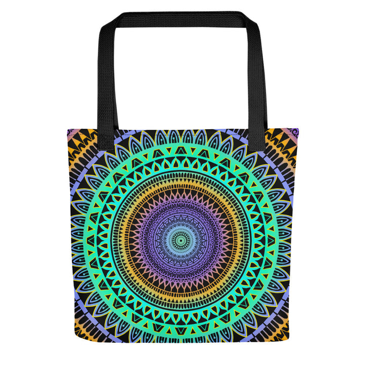 A tote bag with a vibrant mandala design featuring geometric patterns in mint green, purple, and yellow colors.