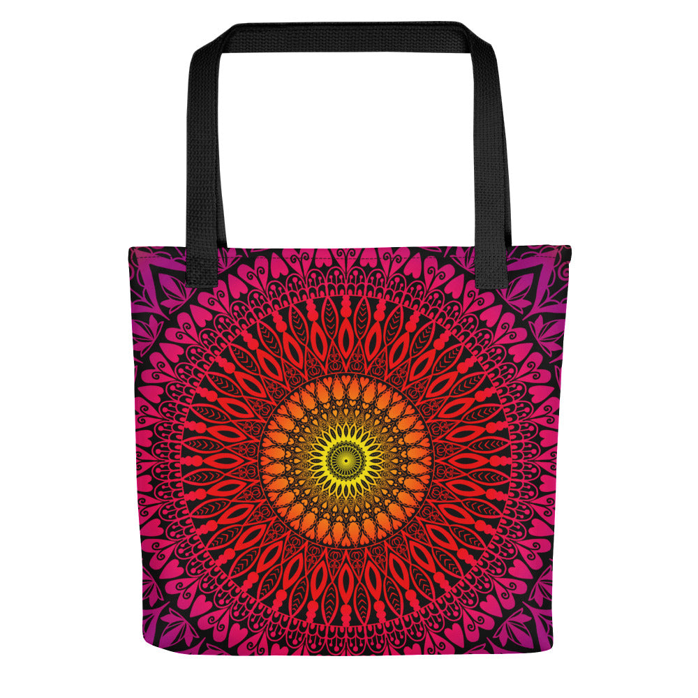 A tote bag featuring a vibrant mandala design with a sunset color palette.