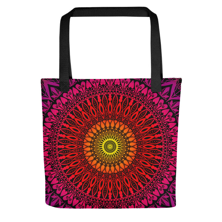 A tote bag featuring a vibrant mandala design with a sunset color palette.