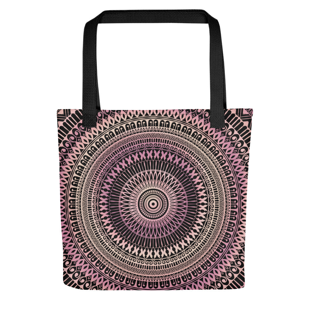 A tote bag featuring a mandala design in pale pink and beige colors on a side view.