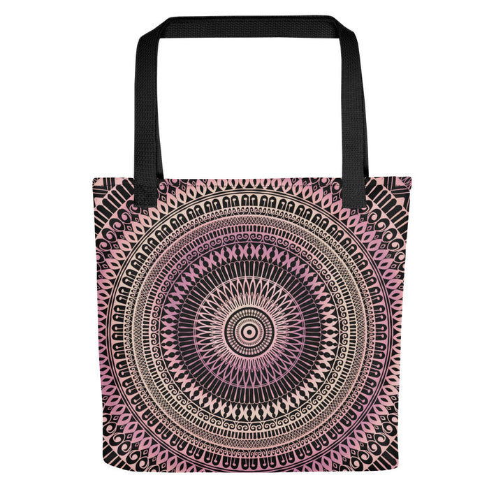 A tote bag featuring a mandala design in pale pink and beige colors on a side view.