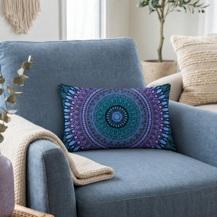 Boho lumbar pillow cover in blue, lavender and black mandala design styled on a dusty blue armchair in a calm boho interior