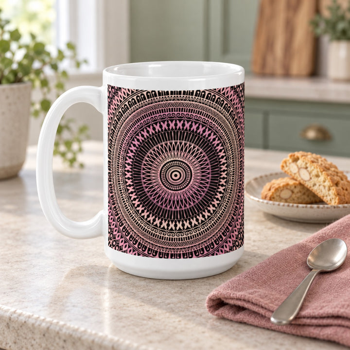 15 oz white ceramic mug with blush pink and beige mandala on a stone kitchen counter beside biscuits.
