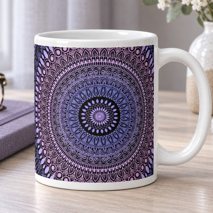 Close-up lifestyle photo of white ceramic mug with pink and lavender mehndi mandala.