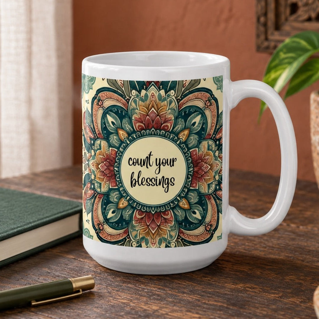 Close-up lifestyle photo of white ceramic Count Your Blessings mug with mandala design.