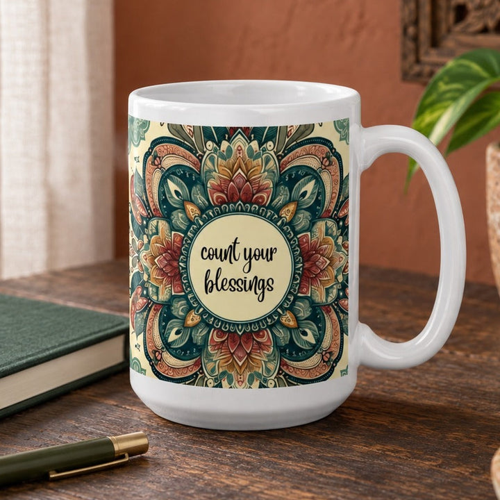 Close-up lifestyle photo of white ceramic Count Your Blessings mug with mandala design.