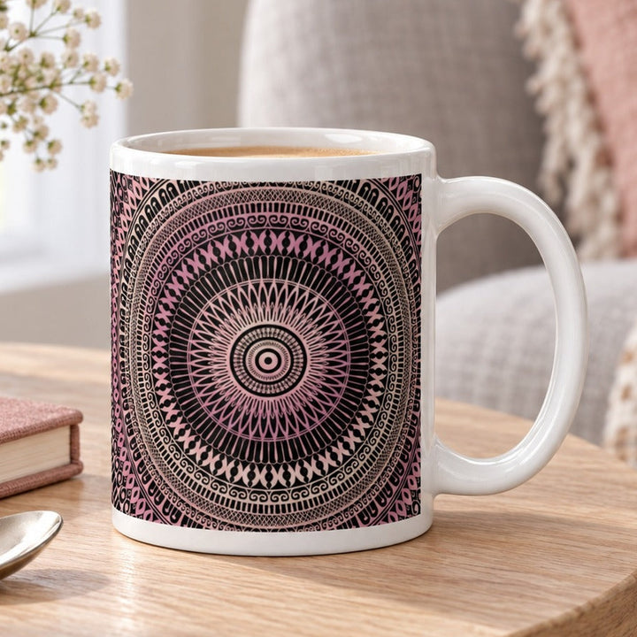 Close-up lifestyle photo of white ceramic mug with blush pink and beige mandala.