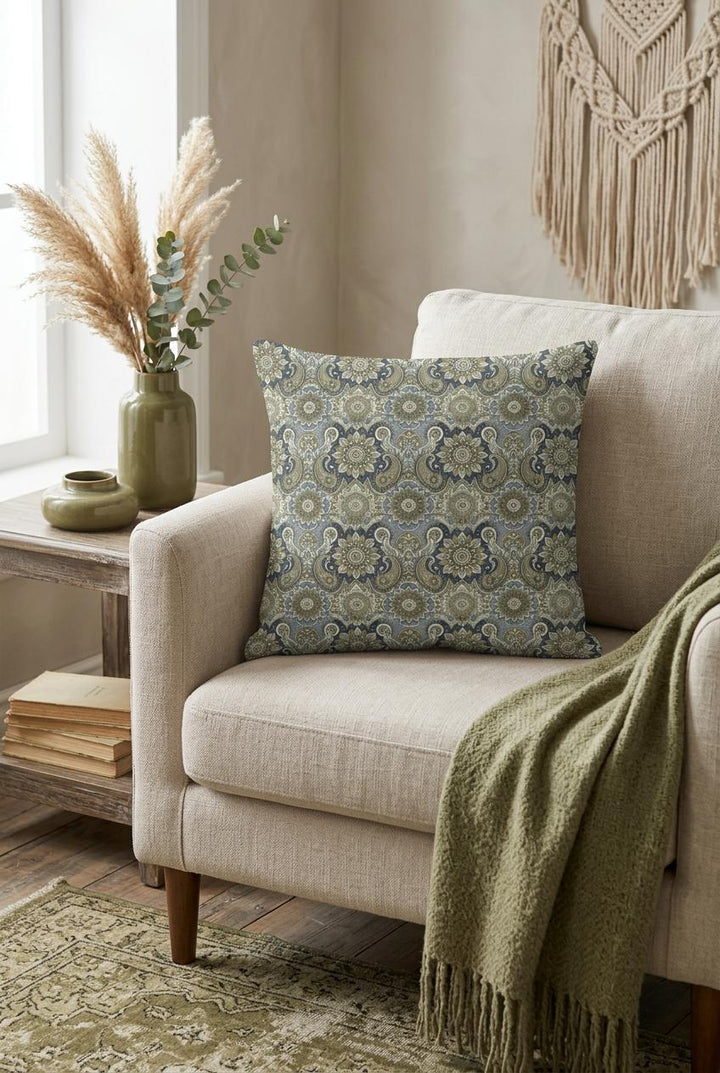 Boho square pillow cover with soft blue, olive green and beige mandala paisley pattern styled in a cozy neutral interior