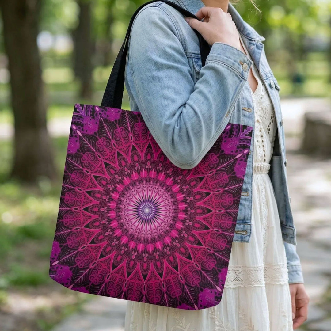 close up boho tote bag with pink mandala print, styled with light dress and denim jacket in natural park setting
