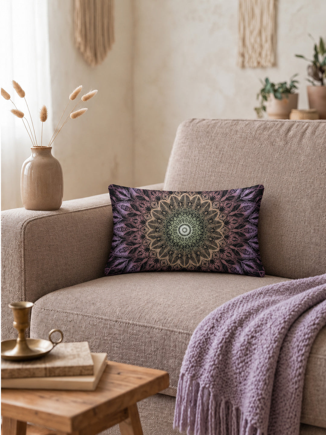 Bohemian lumbar cushion cover with mandala pattern in black, purple and green tones on pastel mauve sofa in warm cozy interior