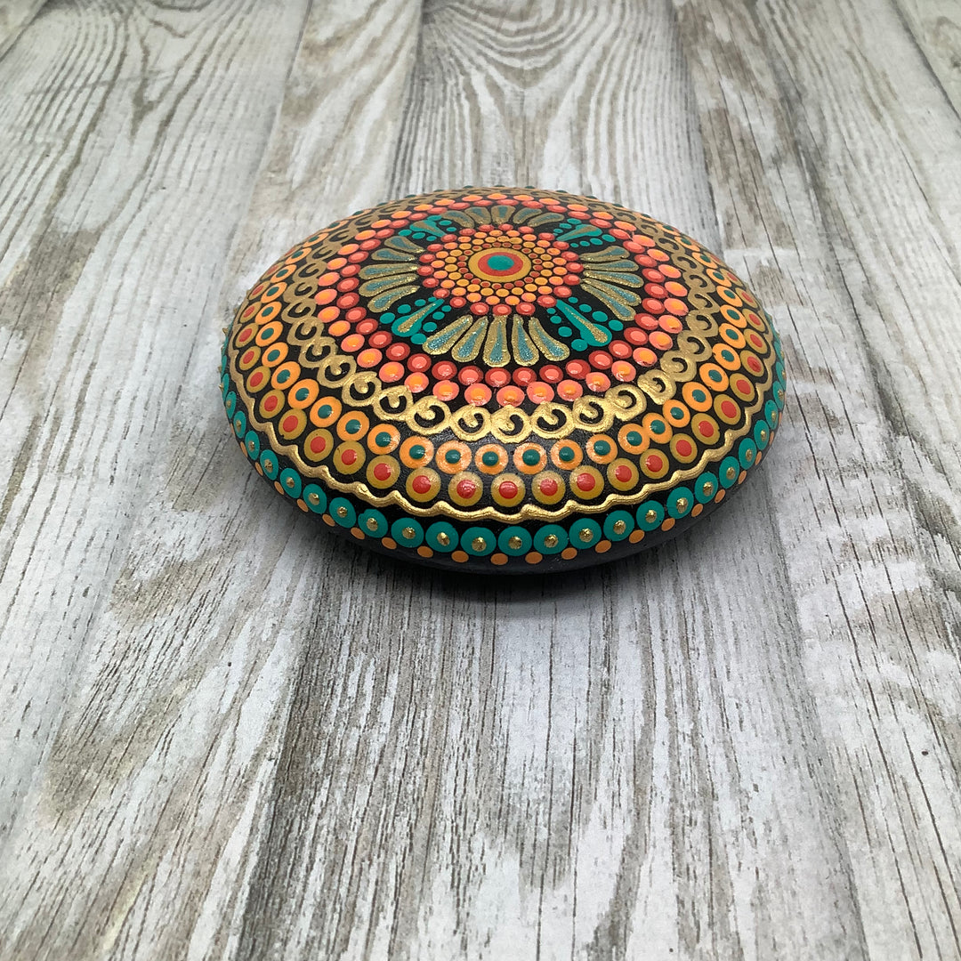 hand painted mandala stone in orange green and gold