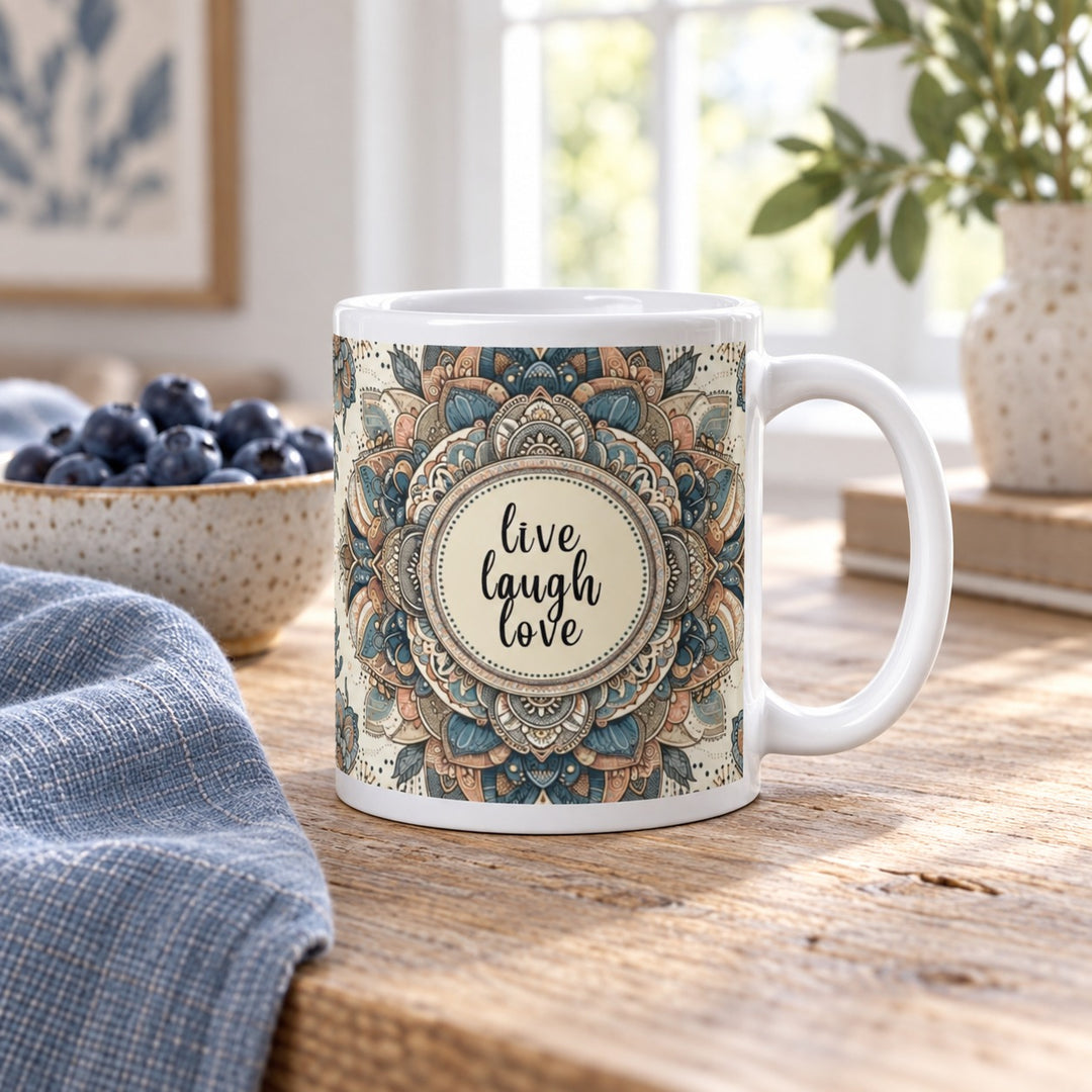 11 oz Live Laugh Love blue mandala mug on a wooden breakfast table beside blueberries and blue linen.