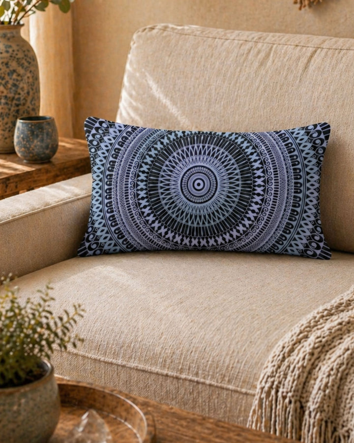 bohemian lumbar pillow with mandala design in black and soft blue tones on beige linen sofa in warm natural interior setting