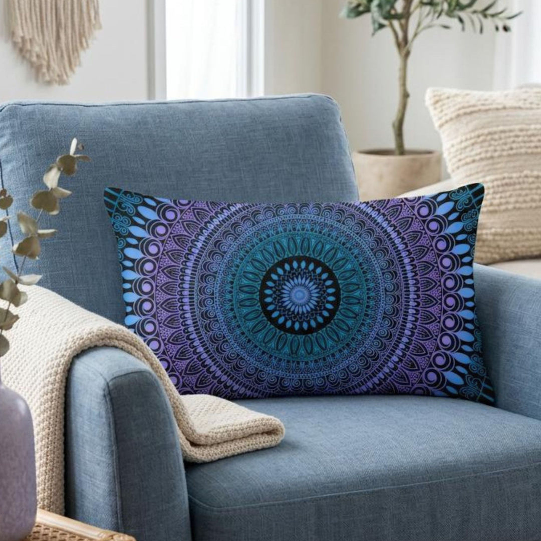 Boho lumbar pillow cover in blue, lavender and black mandala design styled on a dusty blue armchair in a calm boho interior