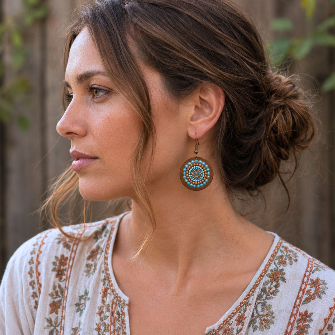 Authentic boho woman wearing handmade mandala earrings in a natural outdoor setting, reflecting the creative and free spirited lifestyle of Boho for Life.