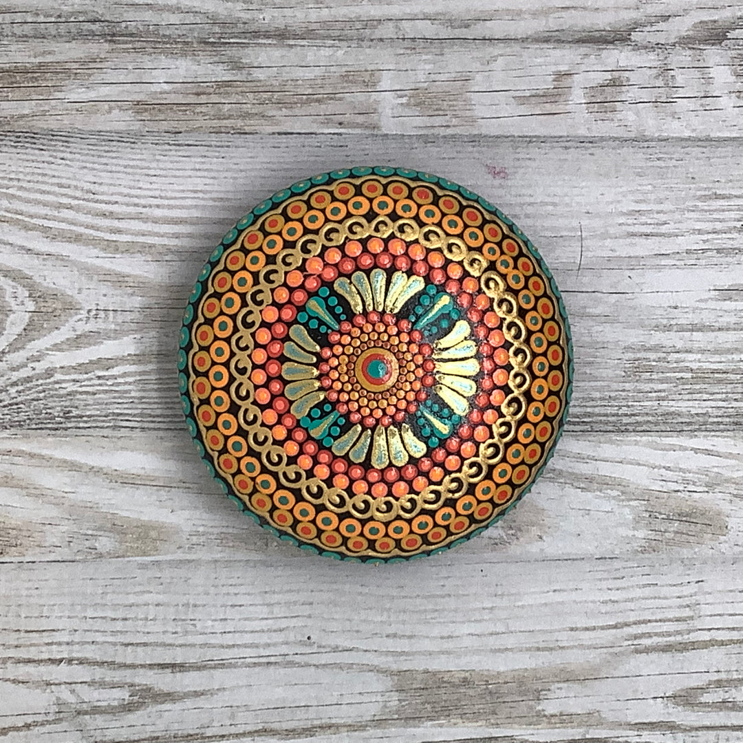 hand painted mandala stone in orange green and gold