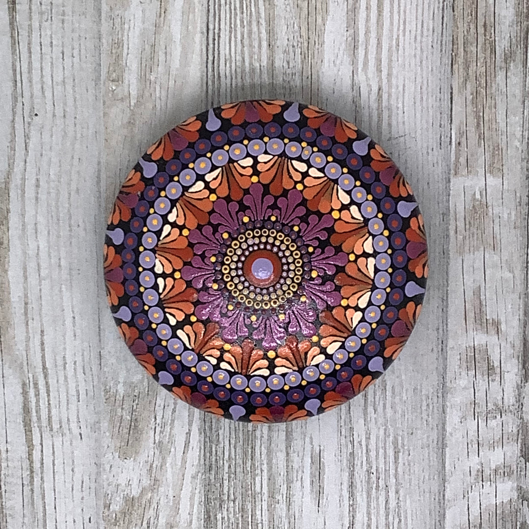 painted mandala rock in pink orange and lavender